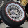 New 15x7" Cadillac 72 Spoke Chrome Cross Lace Wire Wheels & Vogue Whitewall / Red Stripe 215-70-15 Tires Set (4) Fit Rear Wheel Drive Deville Seville Brougham Fleetwood & More RWD Cars - Image 5